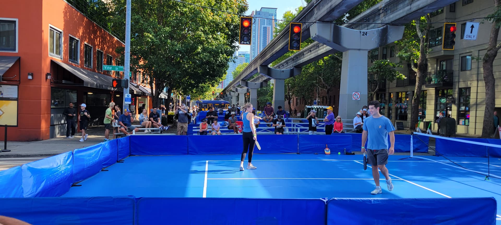 Pop-up rollout pickleball court on a closed city street with spectators